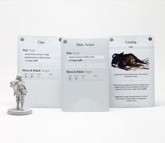 an action figure stands in front of three white cards with information about the creature on them