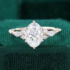 a diamond ring sitting on top of a green cloth