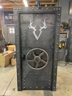 the door is made out of metal and has antlers painted on it's side