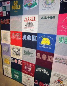 a quilt made to look like many different t - shirts on display in a room