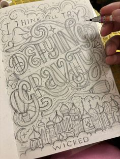 a person holding a pen and drawing some type of lettering on paper with the words, i think it's going to be amazing