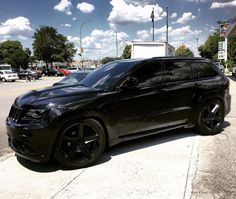 a black suv parked in front of a gas station