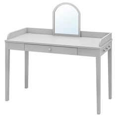 a white dressing table with a mirror on top and drawers underneath it, in front of a white background