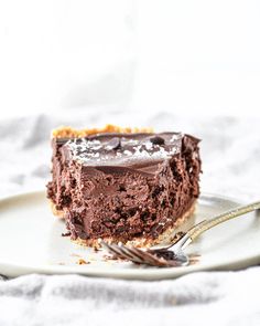 a piece of chocolate cake on a plate with a fork