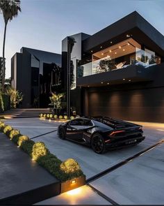 a black sports car is parked in front of a house with lights on the driveway