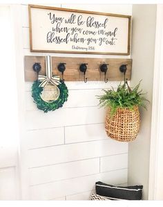 a white wall with some plants hanging on it and a sign that says you will be closed