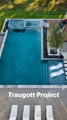 an aerial view of a swimming pool with lounge chairs around it and the words traugtt project written in white