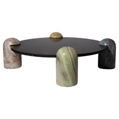 the table is made out of black marble and has three different colored stones on it