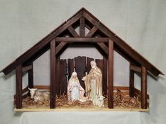 a nativity scene with three wise men in the manger