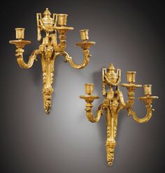 two gold - plated candelabra with candlesticks, possibly from the 19th century