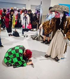 a group of people standing around each other with clowns on their heads and clothes