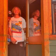 two young men standing in the doorway of a house