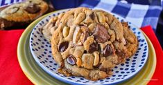 a chocolate chip cookie sitting on top of a blue and yellow plate