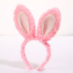 a pink bunny ears headband on a white background