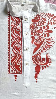 a white shirt with red designs on it