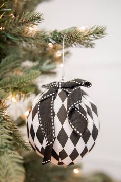 a black and white ornament hanging from a christmas tree