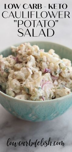 a blue bowl filled with potato salad on top of a white marble counter next to the words low carb keto cauliflower rotator salad