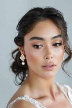 a woman in a white dress with pearls on her head