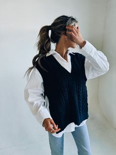 DETAILS: Our Knitted Oversized Vest has a soft and cozy knitted fabric that has an oversized fit. There is a deep v neckline that is outlined with a ribbed look. There is also a ribbed look on the hem and around the opening for the arms. There are two side slits for an open look. This vest does have an oversized look but fits true to size and our model is wearing a small! CONTENT & CARE: SELF: 42% Acrylic, 30% Polyester, 28% Nylon. SIZE & FIT: Model is 5'6" The model is wearing a size Small. Fit Styling An Oversized Sweater Vest, Knitted Vest Dress Outfit, Oversize Knit Vest, Sweater Vest Outfit Oversized, Knit Vest Aesthetic, Oversize Sweater Vest, Business Vest Outfits, Casual Chunky Knit V-neck Sweater For Layering, V-neck Ribbed Sweater For Layering