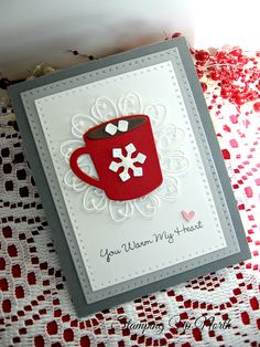 a close up of a greeting card with a coffee cup on the front and snowflakes on the back