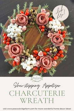 a wreath made out of flowers and berries on top of a wooden board with the words,