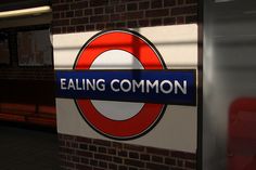 a sign that says eating common on the side of a brick wall next to a bench