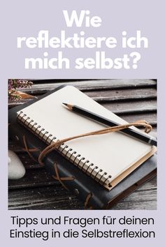 an open notebook sitting on top of a wooden table