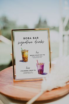 there is a sign that says boba bar signature drinks on the table next to it