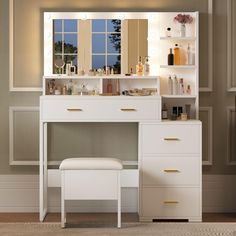 a white dressing table with mirror and stool