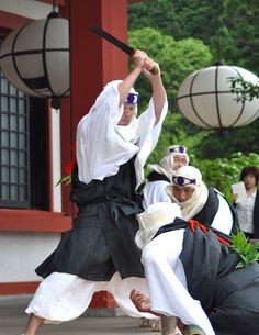 two men in traditional japanese garb performing martial moves