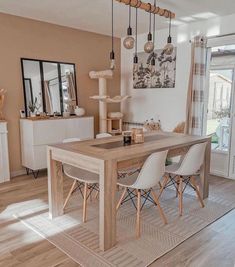 a dining room table and chairs in front of a sliding glass door