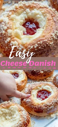 an easy cheese danish with strawberry jam in the center and on top is a hand reaching for it