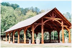 a wooden pavilion with benches under it