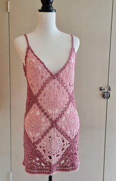 a pink crocheted top on a mannequin