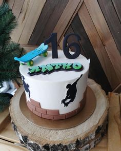 a birthday cake decorated with skateboards and the number sixteen on it's side