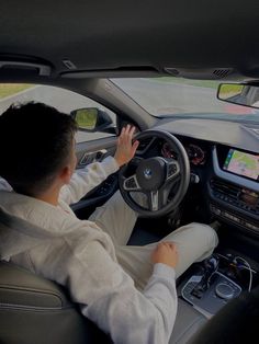 a man sitting in the driver's seat of a car