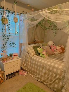 a bedroom with a canopy bed and stuffed animals