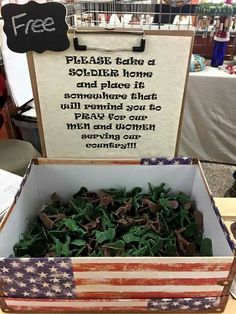 an open box filled with lots of green leaves next to a sign that reads please the soldier home and place it somewhere