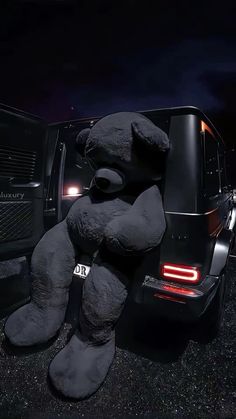 a large stuffed animal sitting on the back of a truck