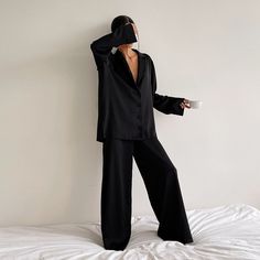 Silk Pajamas that you won't change out of and luckily, don't have to. Wear this soft and silky matching set all day long, or wear it out. Our Olivia Silk Pajamas is another sleepwear favorite this season and features a matching long sleeve top and wide-leg pant bottoms. The pants feature an elasticated waist, silky touch, and high waist. The long-sleeved top features a v-neckline, a loose fit, a single-breasted button closure, and a turn-down collar. The best matching set for lounging around the Pijamas Women, Wide Leg Pant Suit, Pyjama Satin, Pajama Fashion, Satin Sleepwear, Silk Sleepwear, Silk Pajama Set, Satin Pyjama Set, Long Sleeve Tops Casual