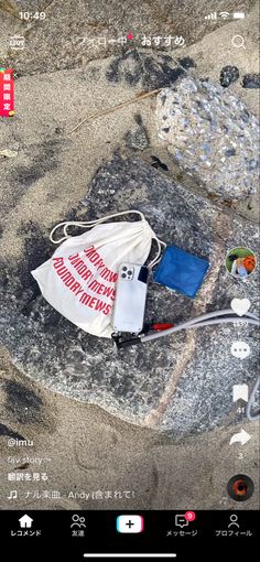 a white bag sitting on top of a rock next to a blue and red flag