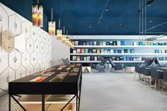 the interior of a book store with tables and chairs