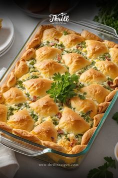 a casserole dish filled with meat and vegetables on top of a white table