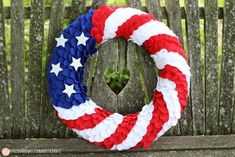 an american flag wreath on a wooden bench