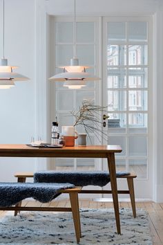 a dining room table with two chairs and a bench