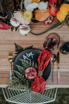 an overhead view of a table setting with plates, silverware and red napkins