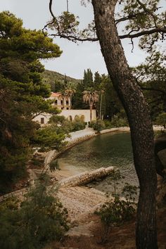 the house is surrounded by trees and water