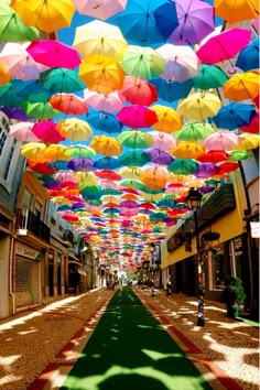 many colorful umbrellas are hanging from the ceiling