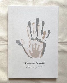 a hand print on a white sheet with the words namba family written in it