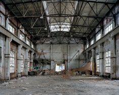 an abandoned building with lots of windows and debris